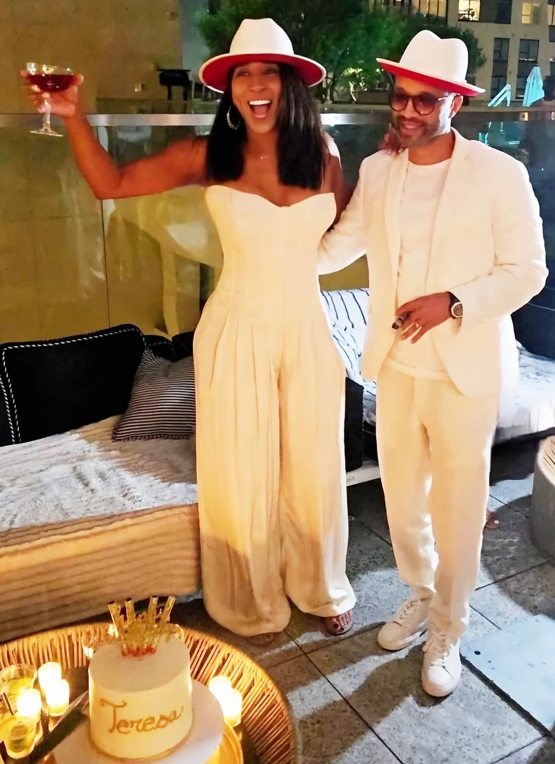 Teresa and Omar McGee celebrating on a rooftop