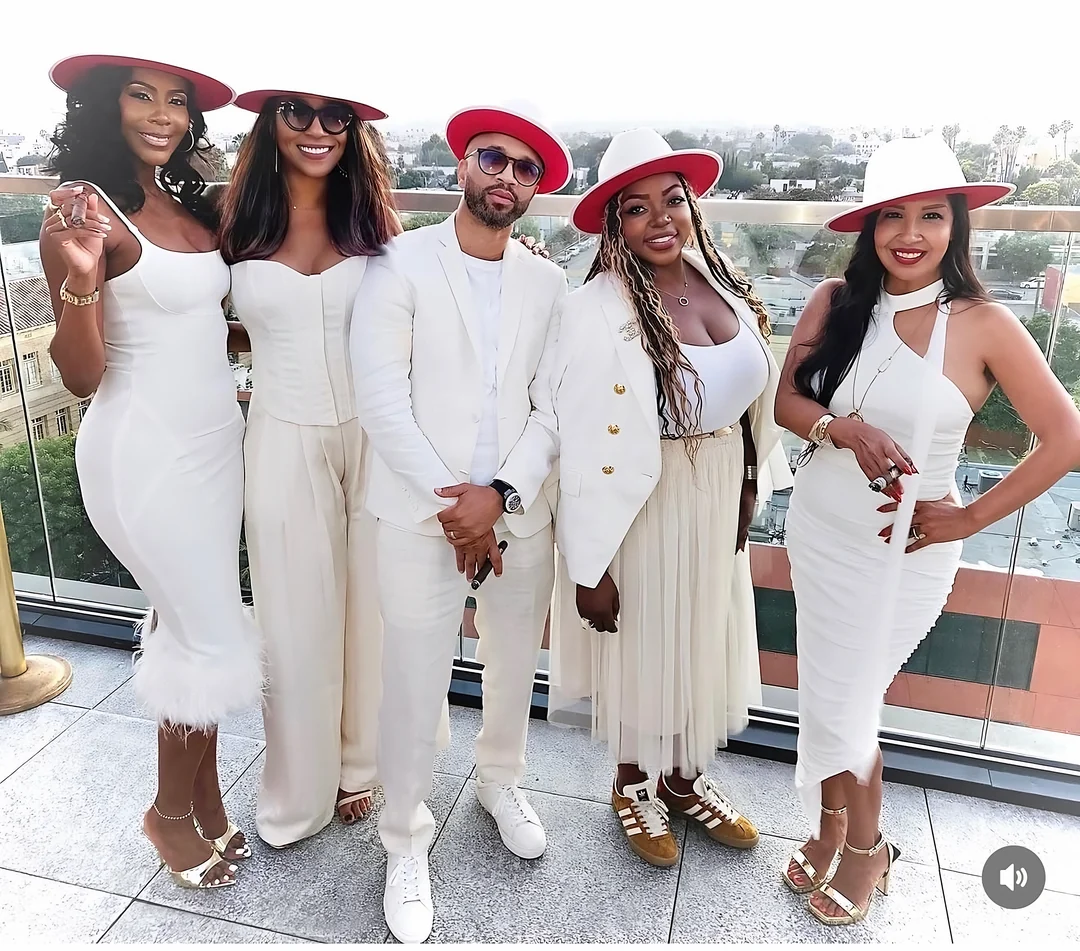 Guests in white on a rooftop with The Rose Gold Reserve