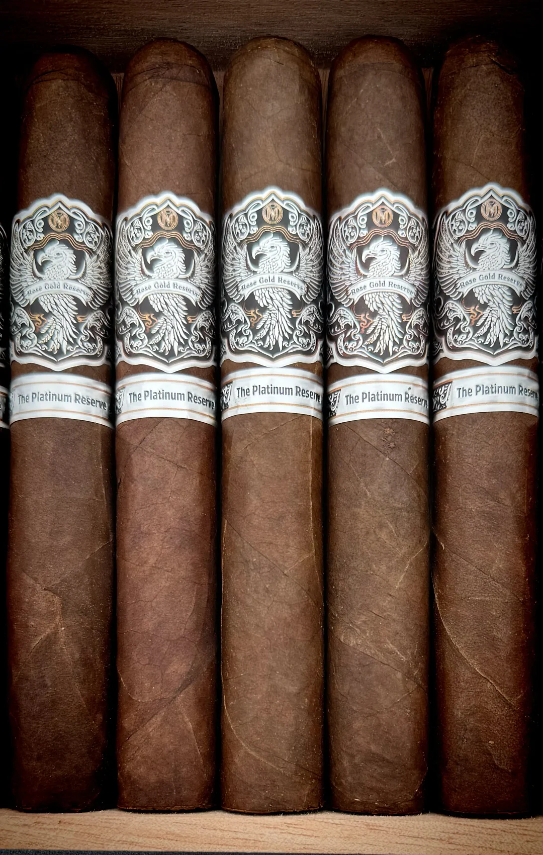 Five Platinum Reserve cigars with white crest bands