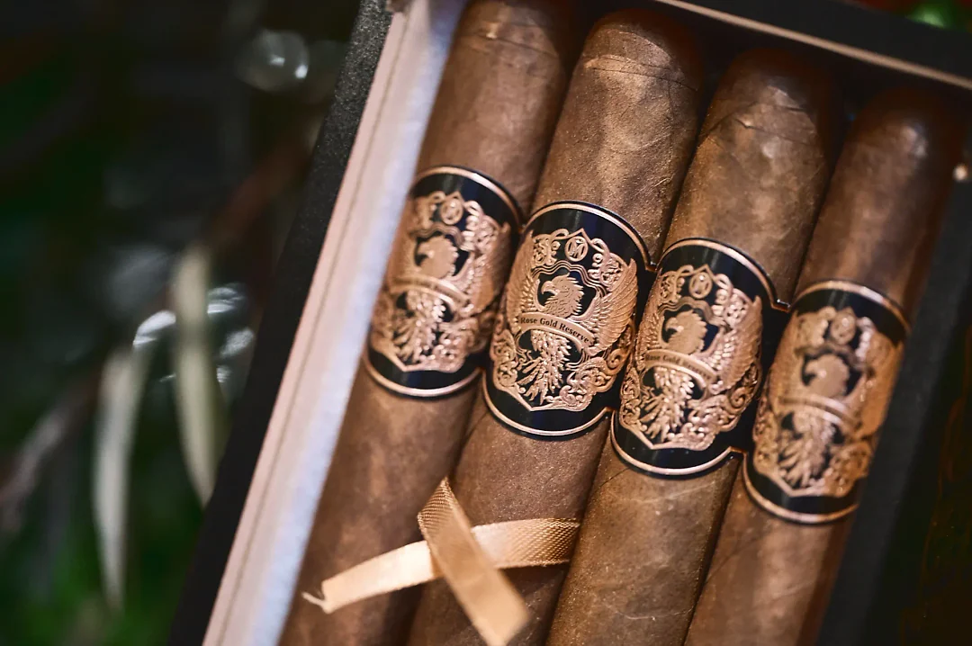 Rose Gold Reserve cigars resting in their black box
